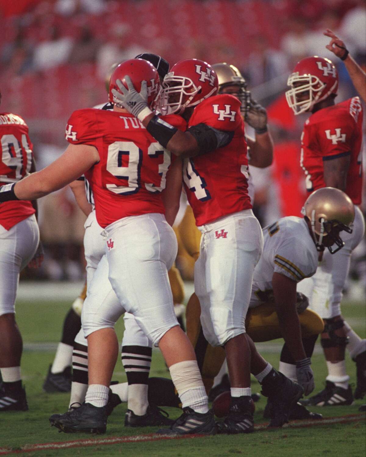 Houston defensive lineman Josh Tubbs, left, is congratulated by teammate Sam Hairston after Tubbs dropped Army running back Michael Wallace for a loss in the first half of UH's stirring come-from-behind win in September 2000. (Houston Chronicle file photo)
