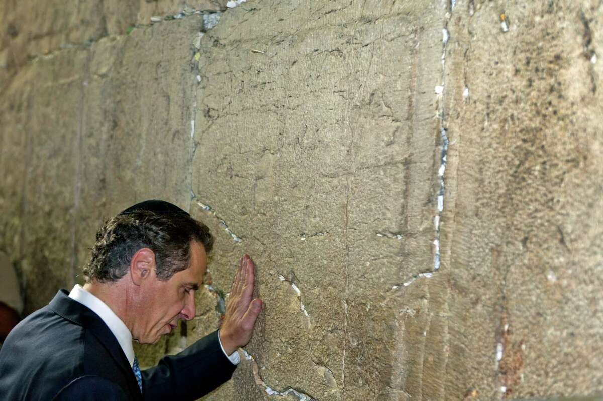 New York Gov. Andrew Cuomo places his hand on the ancient stones of the Western Wall in Jerusalem, Aug. 13, 2014. Cuomo and top New York lawmakers made a visit to Israel to express support in the Gaza conflict this week. A trip coming as more and more American officials are also visiting, eager to show their support. (Rina Castelnuovo/The New York Times) ORG XMIT: XNYT58