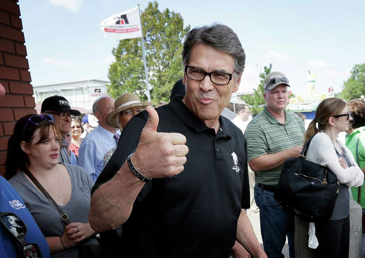 Texas Gov. Rick Perry gives a thumbs-up to supporters before speaking at the Des Moines Register's Political Soapbox at the Iowa State Fair, Tuesday, Aug. 12, 2014, in Des Moines, Iowa. The fair runs through Aug. 17th. (AP Photo/Charlie Neibergall)