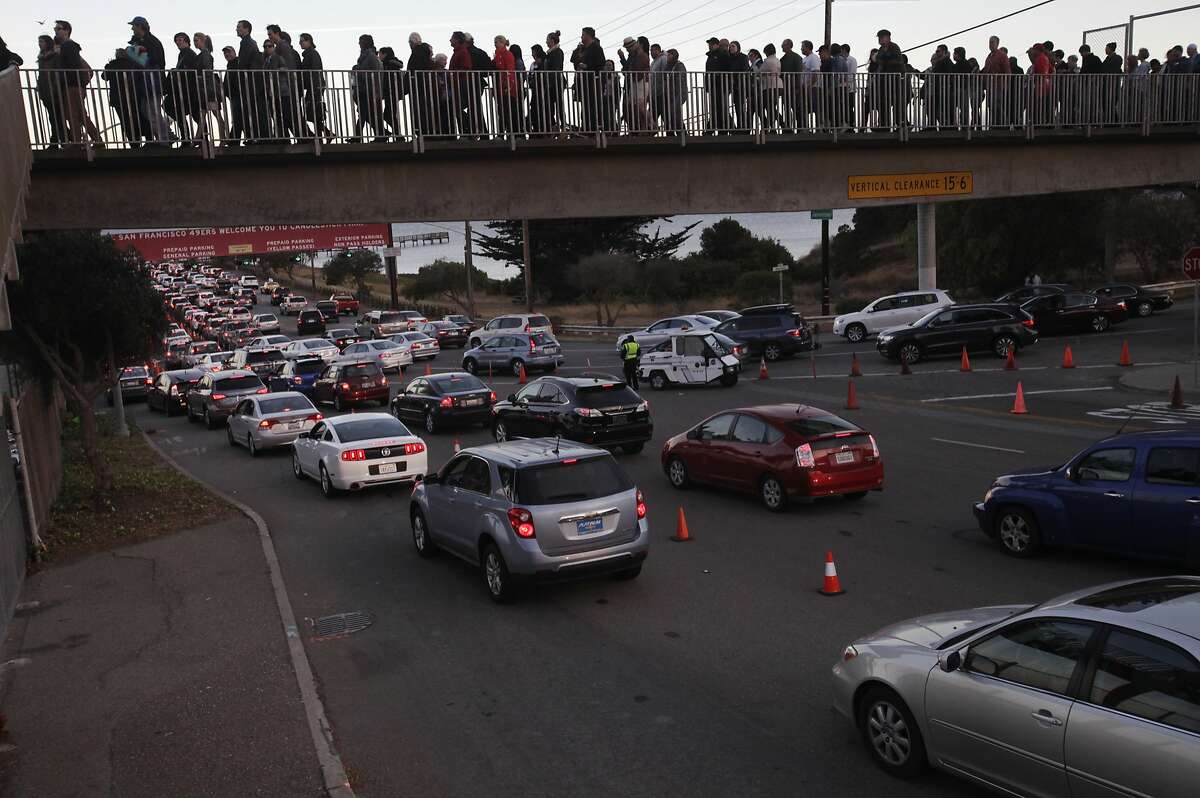 People stream into the entrance of Candlestick Park over backed up traffic before Paul McCartney's "Out There", Farewell to Candlestick Park concert August 14, 2014 in San Francisco, Calif.