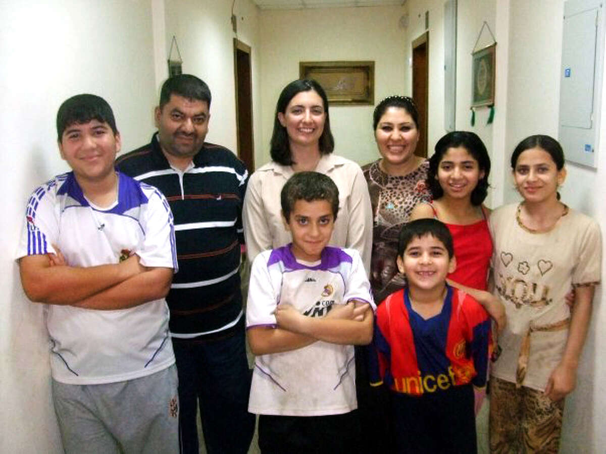 Judge Hussen Al-Anbaki stands with his family and Bridgeport Deputy Assistant StateâÄôs Attorney Emily Dewey Trudeau (center) in this photograph taken in Iraq in 2008. For more than five years Judge Al-Anbaki worked alongside U.S. troops battling to bring terrorists to justice in Iraq. Dewey Trudeau is now trying to help bring the judge and his family to the U.S.