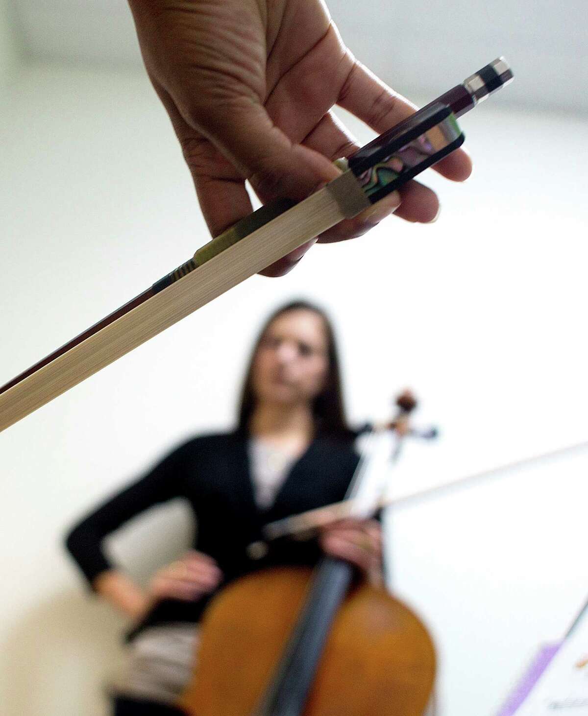 Instructor Annamarie Reader listens as a student practices at the Vivaldi Music Academy in Bellaire.