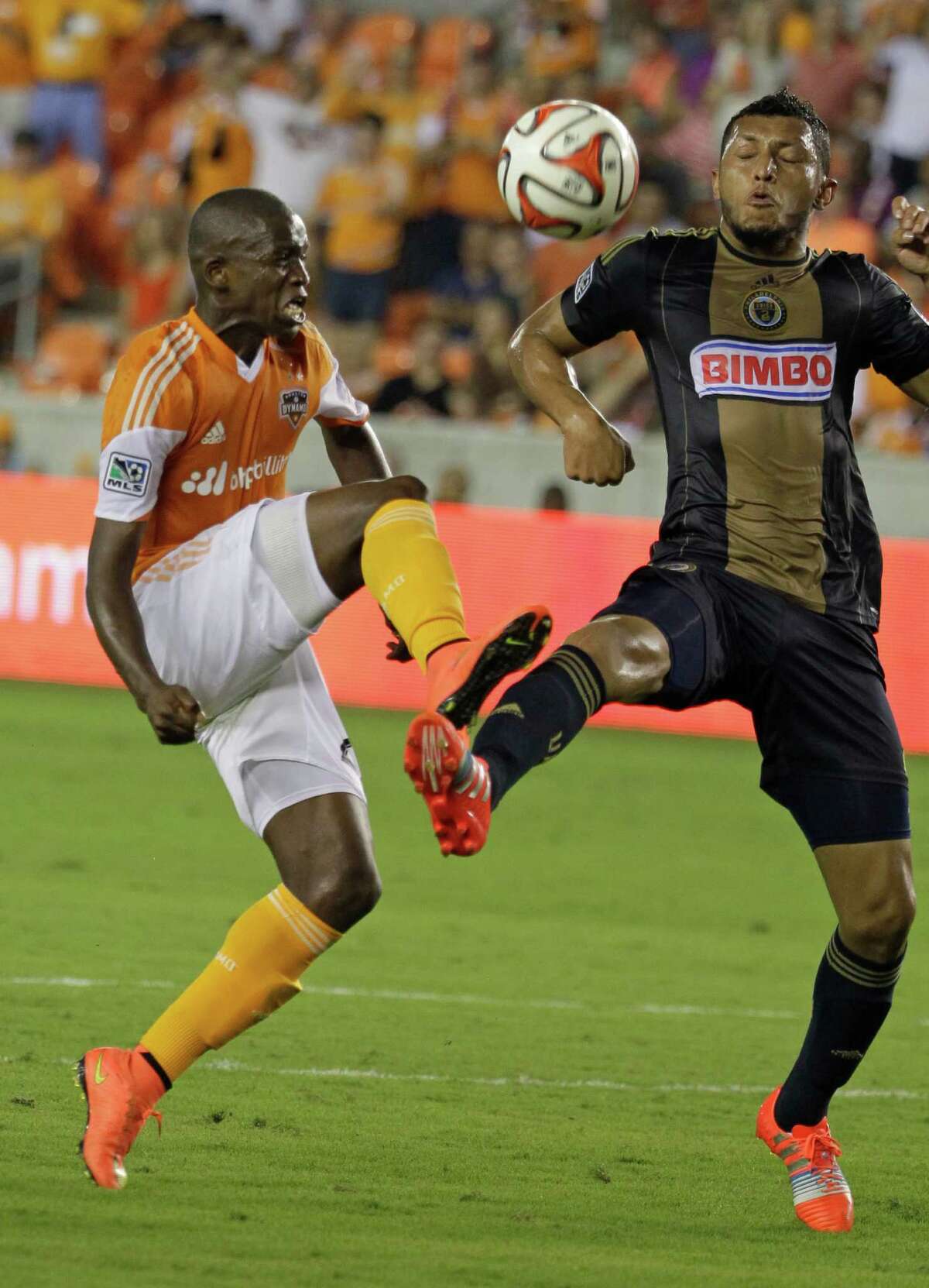 Houston Dynamo Boniek Garcia, left, and Philadelphia Union Carlos Valdes battle for the ball during the first half of game at BBVA Compass Stadium Friday, Aug. 15, 2014, in Houston.