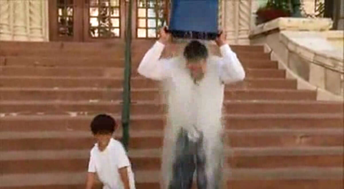District 8 City Councilman Ron Nirenberg and his son take the ALS ice bucket challenge Friday, Aug. 15, 2014, on the step of San Antonio's City Hall.