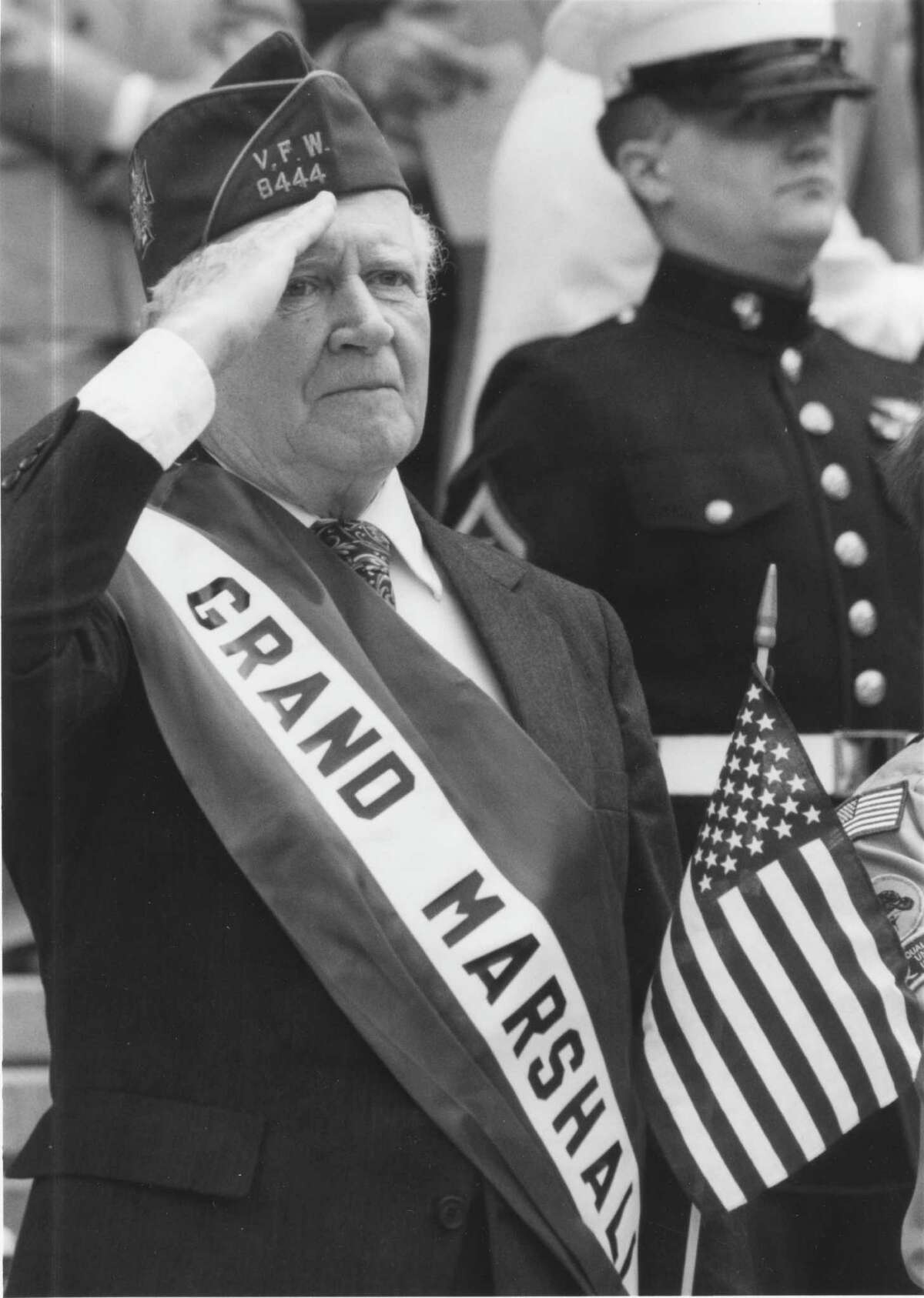 Raymond F. Joyce Jr. salutes from the reviewing stand in front of the state Education Department after serving as grand marshal of Albany's 1993 Memorial Day parade. (Times Union Archive)