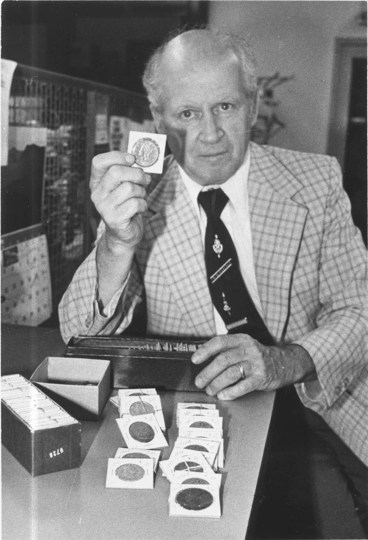 Former Albany city Treasurer Raymond F. Joyce Jr. holds up an 1883 $20 gold piece in this 1982 file photo. (Times Union Archive)