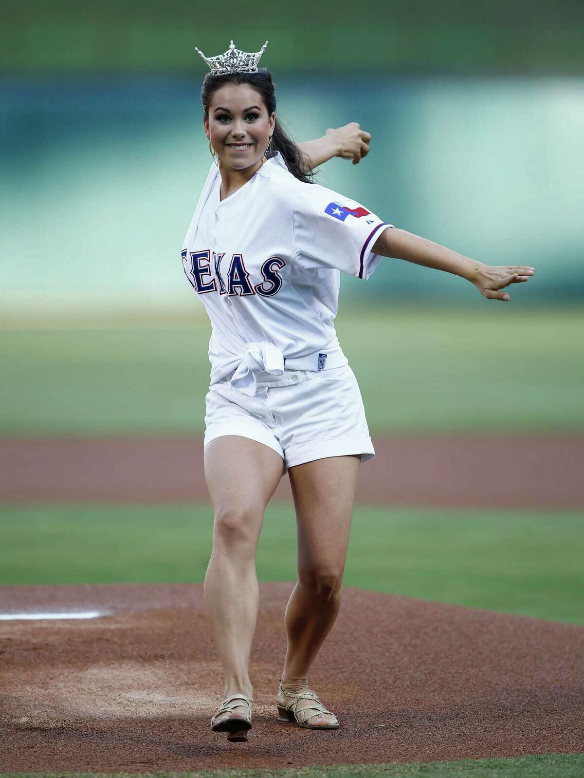 Miss Texas 2014 Monique Evans throws out the ceremonial first-pitch before the baseball between the Los Angeles Angels and the Texas Rangers, Friday, Aug. 15, 2014, in Arlington, Texas.
