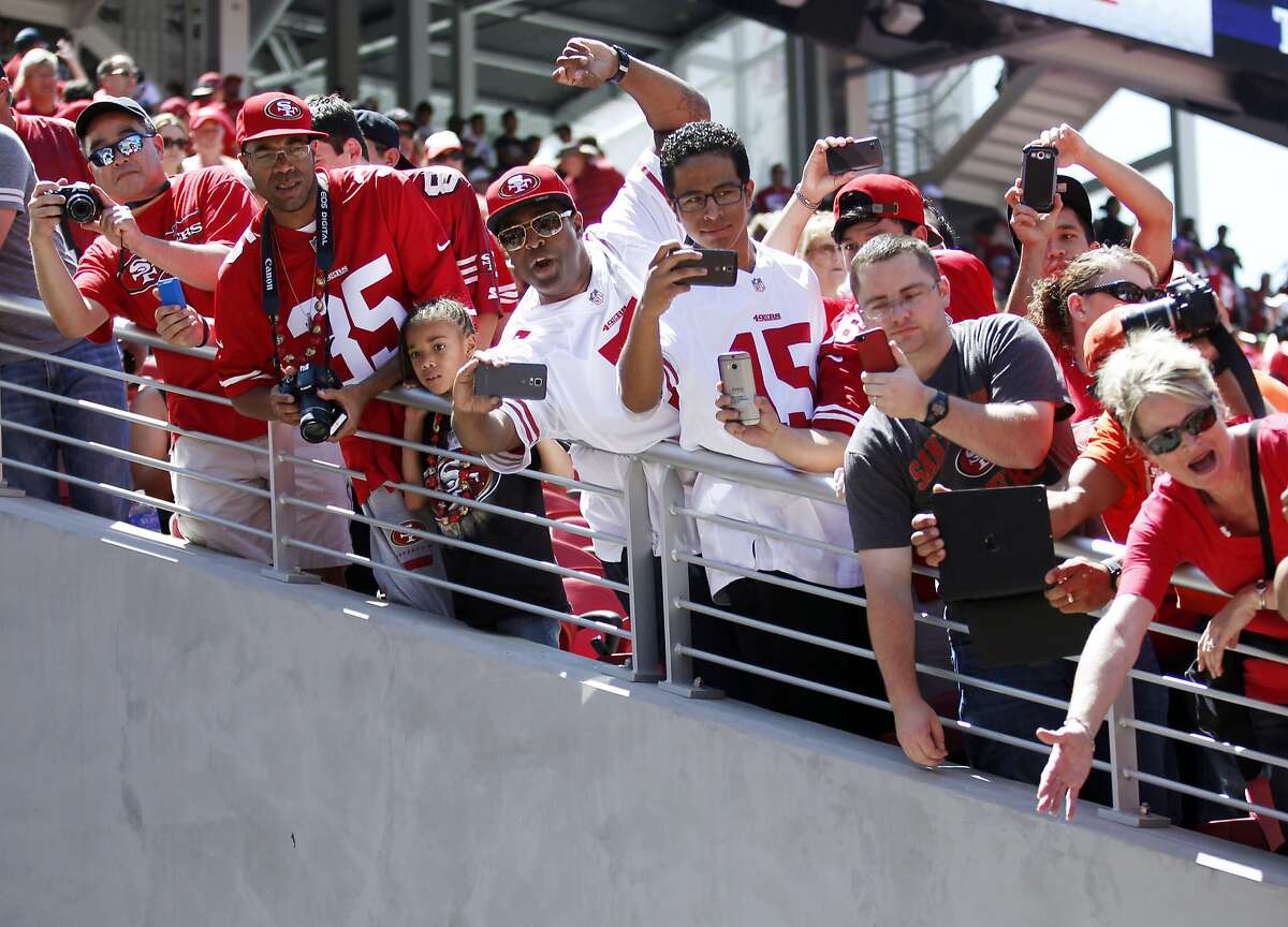 Fans cheer on the San Francisco 49ers as the leave the field following warm ups before their football game against the Denver Broncos on Sunday, August 17, 2014 in Santa Clara, Calif.