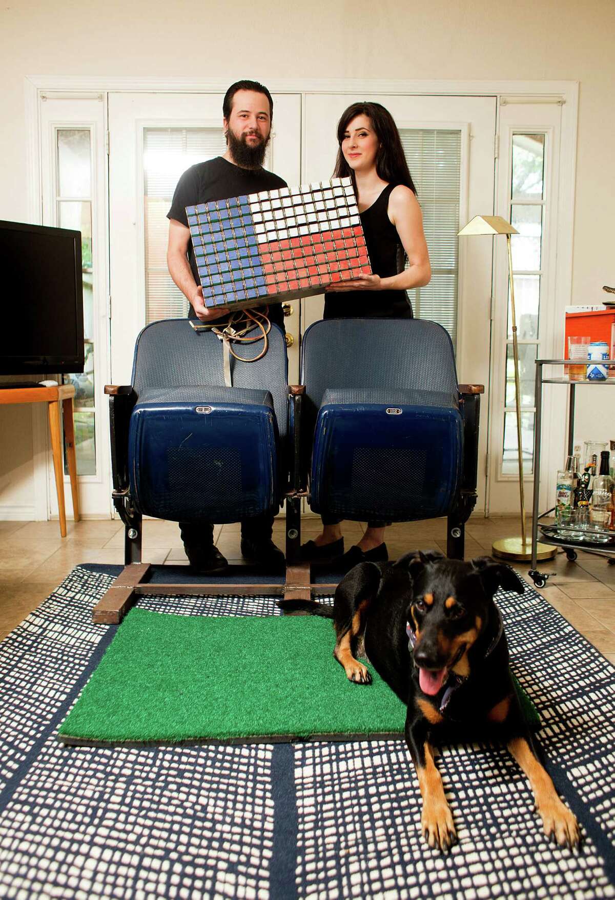 Megan Ross, 30, and Brad Corona, 28 - and their Ruby - show off their salvaged iconic Astrodome memorabilia. ﻿