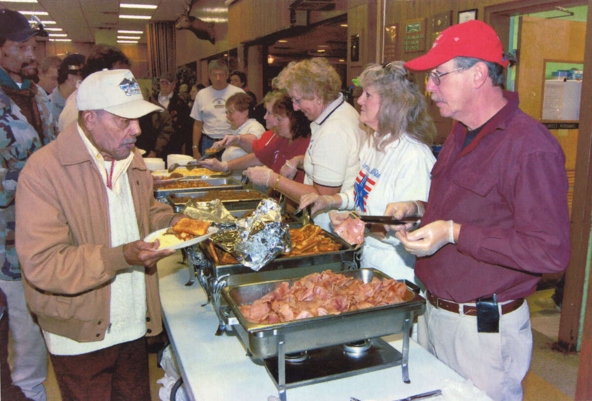Volunteers feed veterans during an Eastern New York State Homeless Veterans Coalition's Homeless Veterans Stand-Down in 2012 at the Colonie Elks Lodge in Latham.