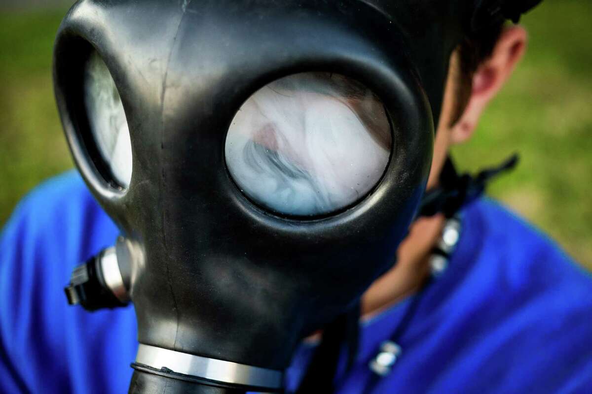 Thick, white marijuana smoke cloaks the eyeholes of a mask bong on the final day of Hempfest, Seattle's annual gathering to advocate the decriminalization of marijuana, photographed Sunday, August 17, 2014, at Myrtle Edwards Park on the Seattle waterfront in Seattle, Washington. The three-day annual event includes political rallies, concerts, and an arts and crafts fair.