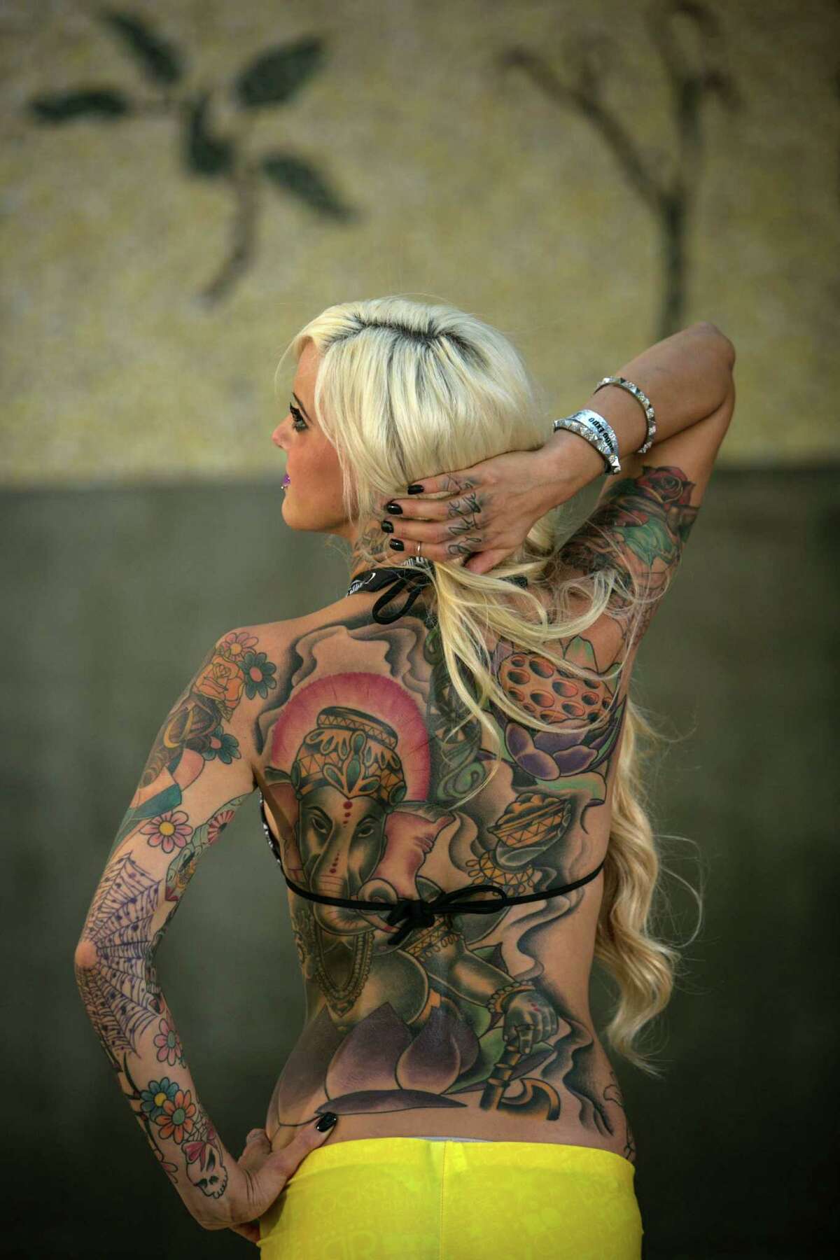 Erin shows her ink during the 13th annual Seattle Tattoo Expo at Fisher Pavilion at the Seattle Center. Photographed on Sunday, August 17, 2014.