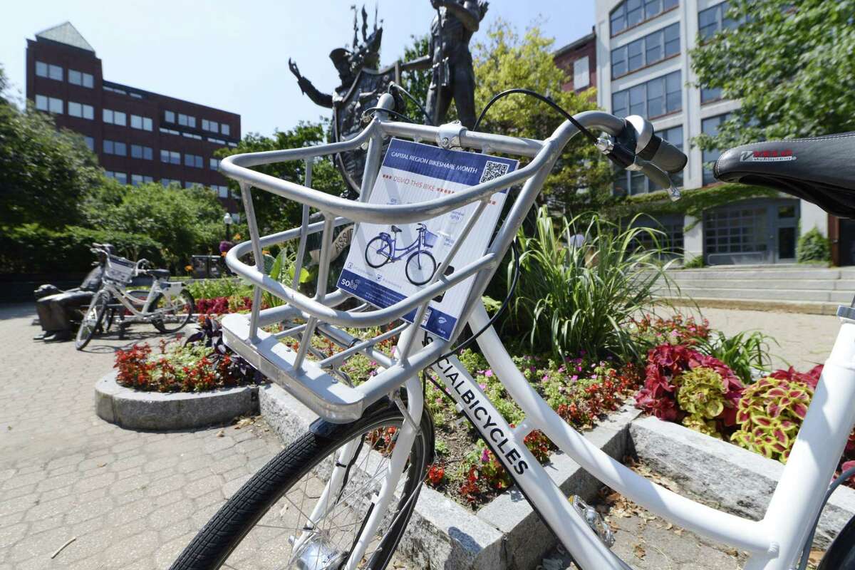 One of the bicycles available to share during Albany's BikeShare week is locked to a bench Monday, Aug. 11, 2014, at Tricentennial Square in Albany, N.Y. (Will Waldron/Times Union)