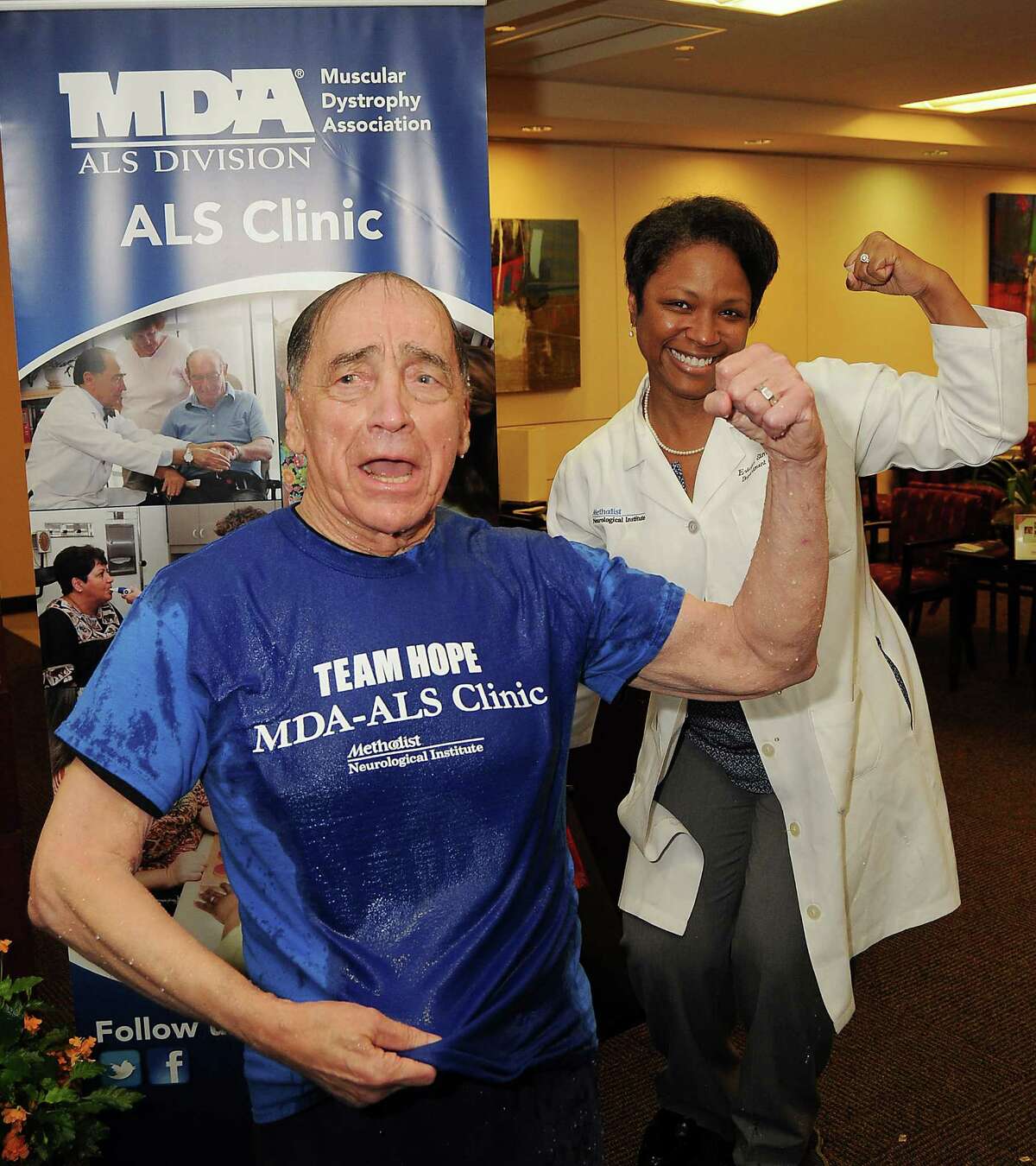 Dr. Stanley Appel and Dr. Ericka Simpson flex after an Ice Bucket Challenge at the Muscular Dystrophy Association ALS Clinic at the Houston Methodist Neurology Institute Monday Aug. 18. Keep clicking to see other people from Houston and Texas who have taken the challenge.