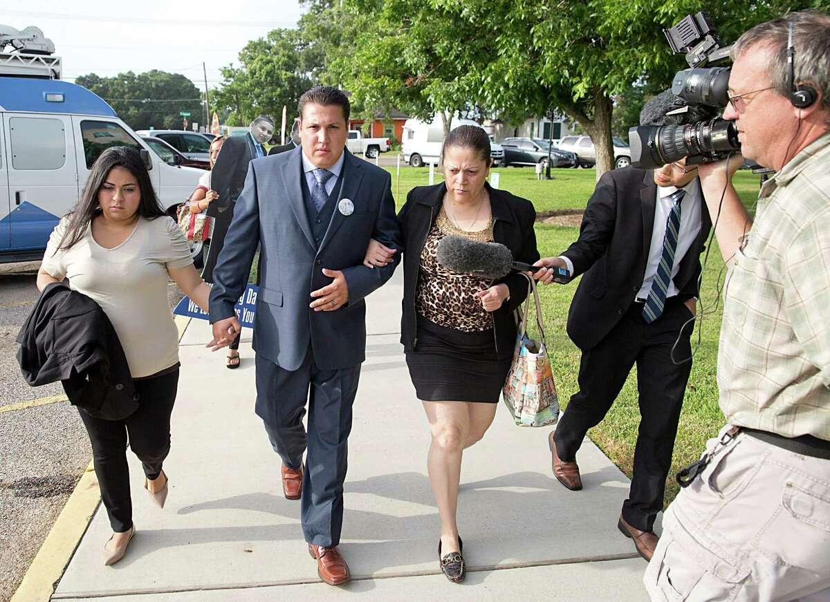 David Barajas walks with his wife, Cindy Barajas, left and his step mother, right, Betty Hernandez as he walk toward court on August 19, 2014 in Angleton, TX. David Barajas is accused of fatally shooting drunken driver, Jose Banda who killed his young sons, David Jr., age 12 and Caleb, age 11.
