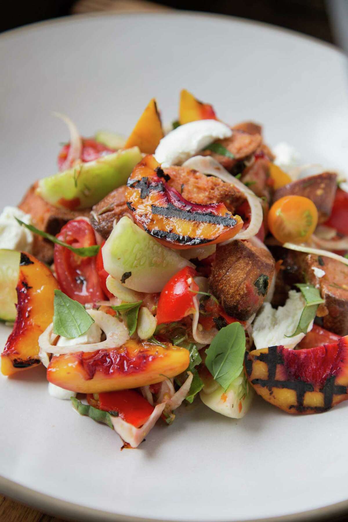 Summer stone fruit goes into panzanella made by Melissa Perello.