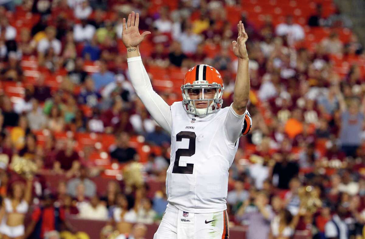 Cleveland Browns quarterback Johnny Manziel (2) celebrates running back Dion Lewis (28) scoring a touchdown on a pass, during the second half of an NFL preseason football game against the Washington Redskins Monday, Aug. 18, 2014, in Landover, Md. (AP Photo/Evan Vucci)