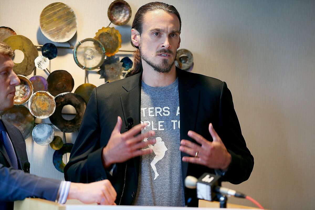 FILE - In this July 15, 2014, file photo, former Minnesota Vikings punter Chris Kluwe, right, speaks during a press conference in Minneapolis. Kluwe says he's reached a settlement with the team to avert a threatened lawsuit over his release. Kluwe had accused the Vikings of cutting him over his activism on gay rights issues. He said Tuesday, Aug. 19, 2014, that the Vikings have agreed to donate to several nonprofits to help raise awareness in professional sports about LGBT issues. (AP Photo/The Star Tribune, Elizabeth Flores, File ) MANDATORY CREDIT; ST. PAUL PIONEER PRESS OUT; MAGS OUT; TWIN CITIES TV OUT