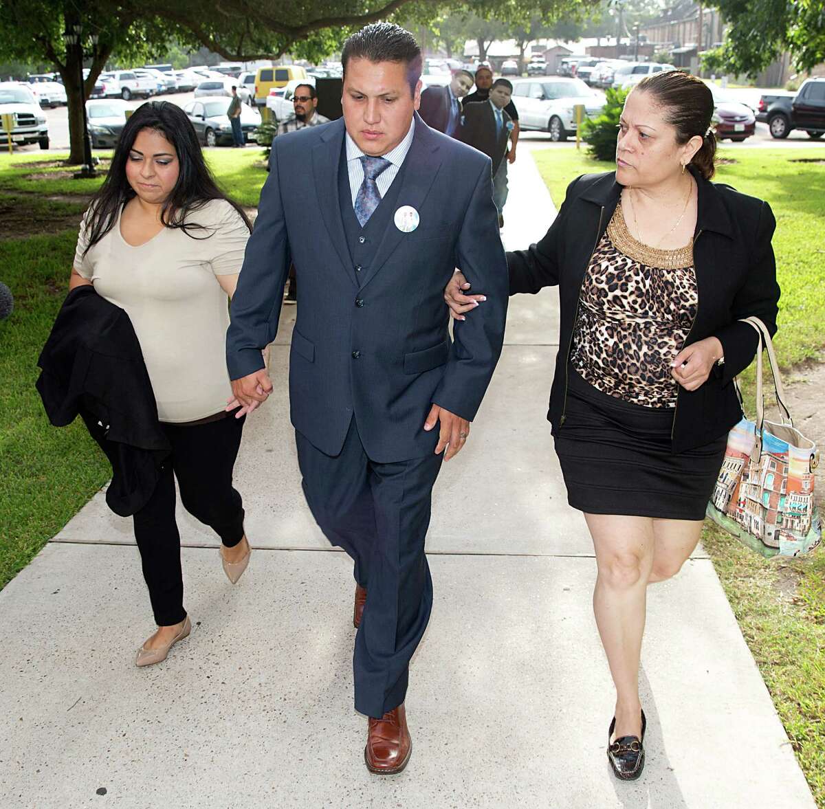 David Barajas, charged with murder, walks with wife, Cindy, left, and stepmother, Betty Hernandez, into court in Angleton. ﻿