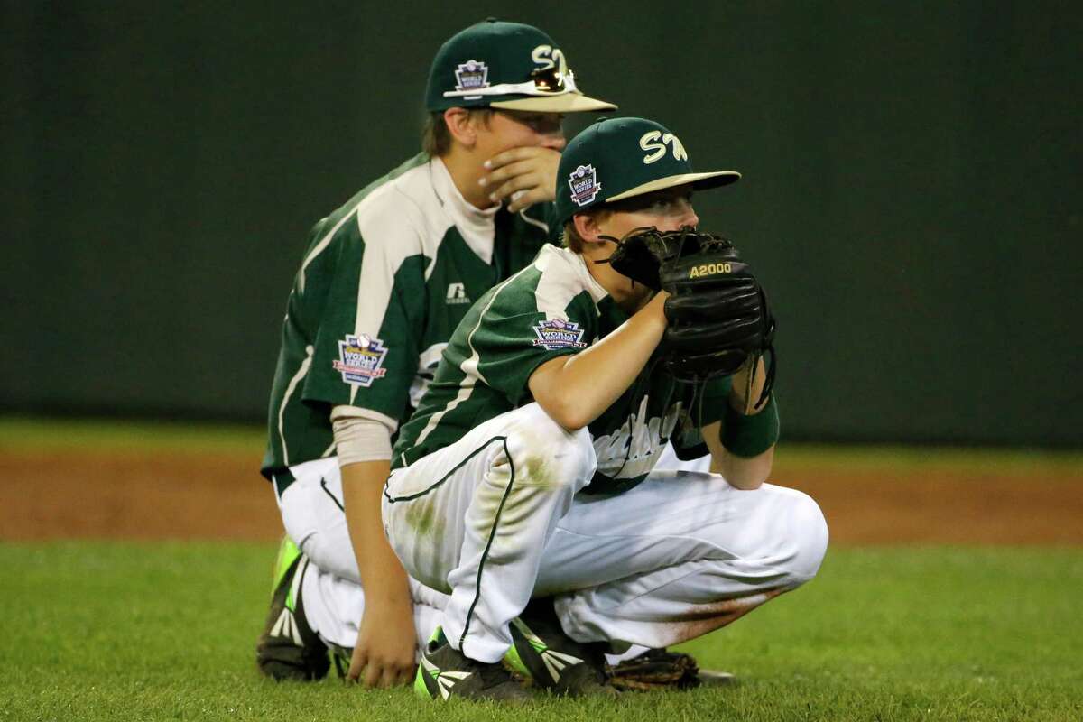 Pearland first baseman Layne Roblyer, rear, and second baseman Brandon Sliwinski wait during a pitching change in the fifth inning of an elimination baseball game against Chicago at the Little League World Series tournament in South Williamsport, Pa., Tuesday, Aug. 19, 2014. Chicago won 6-1. (AP Photo/Gene J. Puskar)