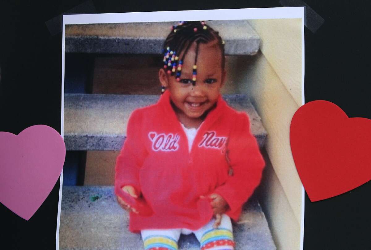A family photograph of Mi'yana Gregory is part of a memorial for the two-year-old on Mission Street between Fourth and Fifth streets in San Francisco, Calif. on Wednesday, Aug. 20, 2014. Mi'yana was hit and killed by a hit and run driver as she was crossing the street in the crosswalk Saturday night. Police arrested Mi'yana's aunt for allegedly leaving the the girl in the street unattended, while the search for the driver continues.