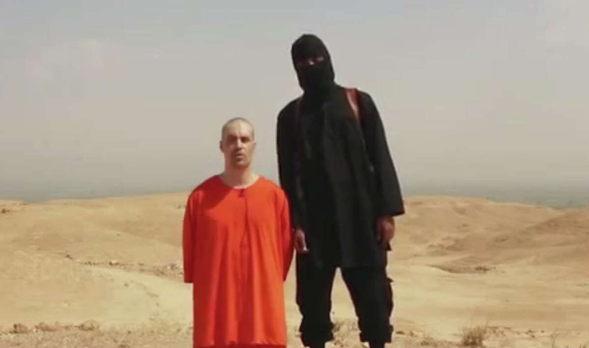 This undated image shows a frame from a video released by Islamic State militants Tuesday, Aug. 19, 2014, that purports to show the killing of journalist James Foley by the militant group. Foley, from Rochester, N.H., went missing in 2012 in northern Syria while on assignment for Agence France-Press and the Boston-based media company GlobalPost. The U.S. Department of Homeland Security is refuting several claims peddled by conservative groups and lawmakers that militants for the Islamic State in Iraq and Syria are operating just south of the Texas-Mexico border.