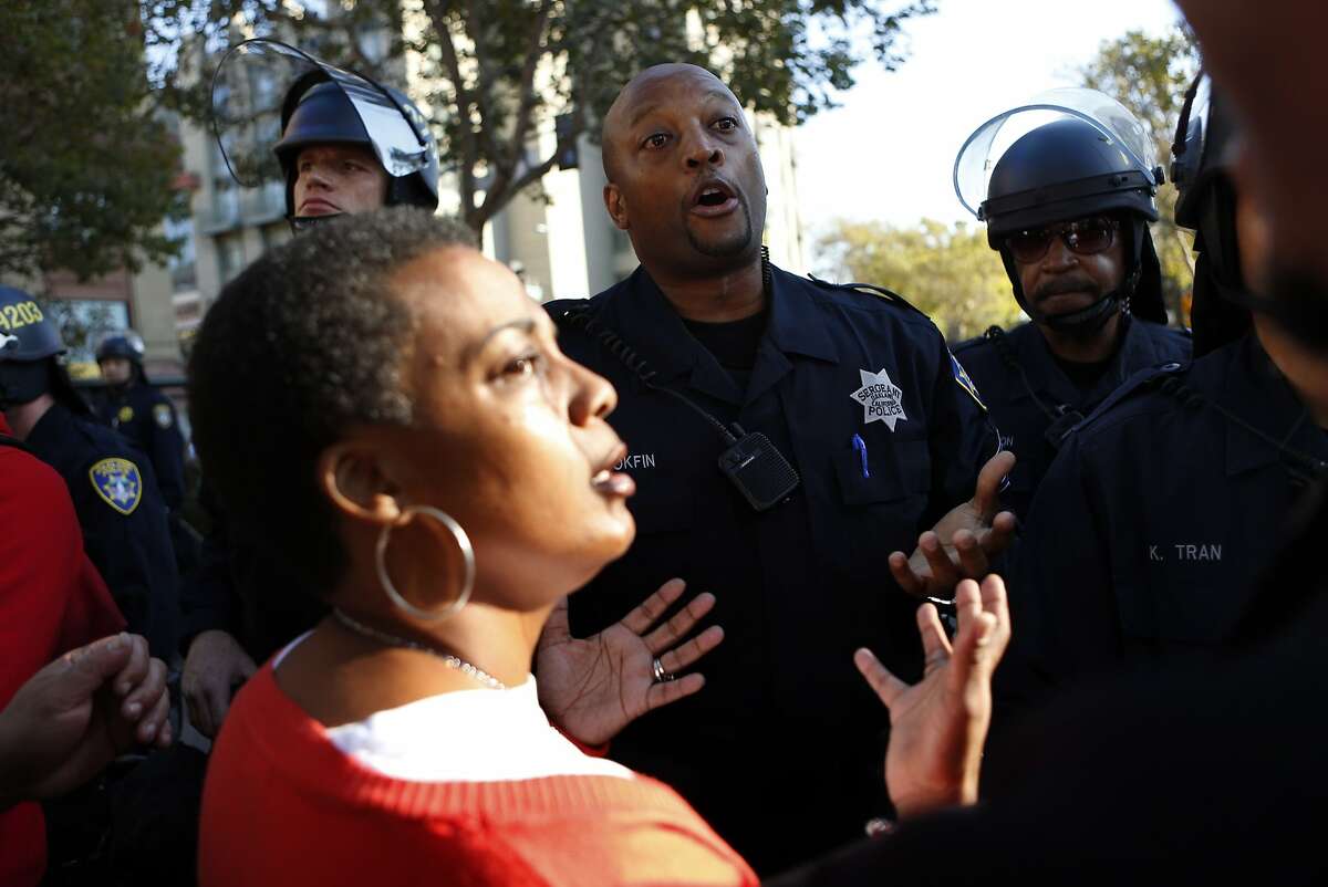 Oakland Police Sgt. Bobby Hookfin talks with Jeralynn Blueford after a protest march in support of Ferguson, Missouri residents was stopped short of police headquarters in Oakland, Calif. on Wednesday, August 20, 2014.