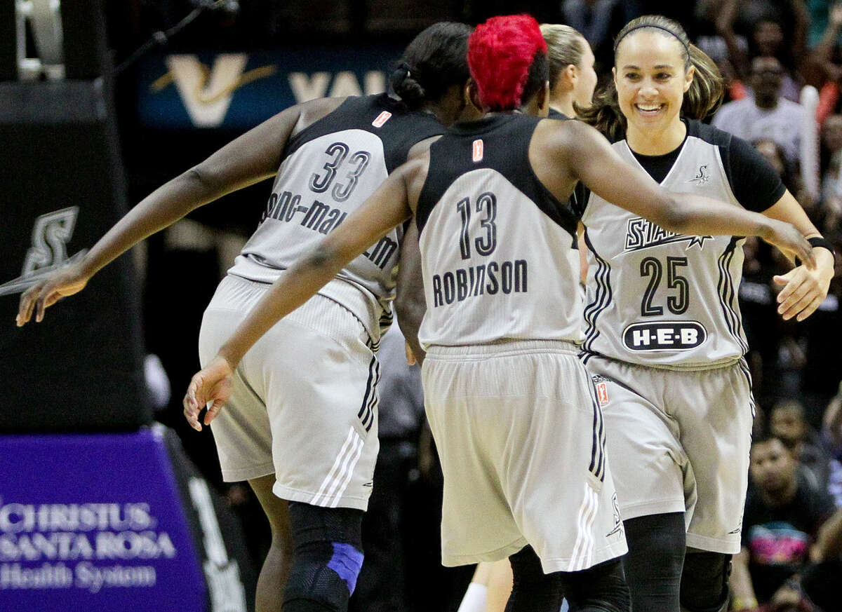 Danielle Robinson (13) congratulates Becky Hammon (right) after Hammon's three-point shot with 26.2 seconds remaining in the game to put the Stars up 78-74 over the Los Angeles Sparks at the AT&T Center on Sunday, Aug. 10, 2014. The Stars beat the Sparks 82-76. MARVIN PFEIFFER/ mpfeiffer@express-news.net