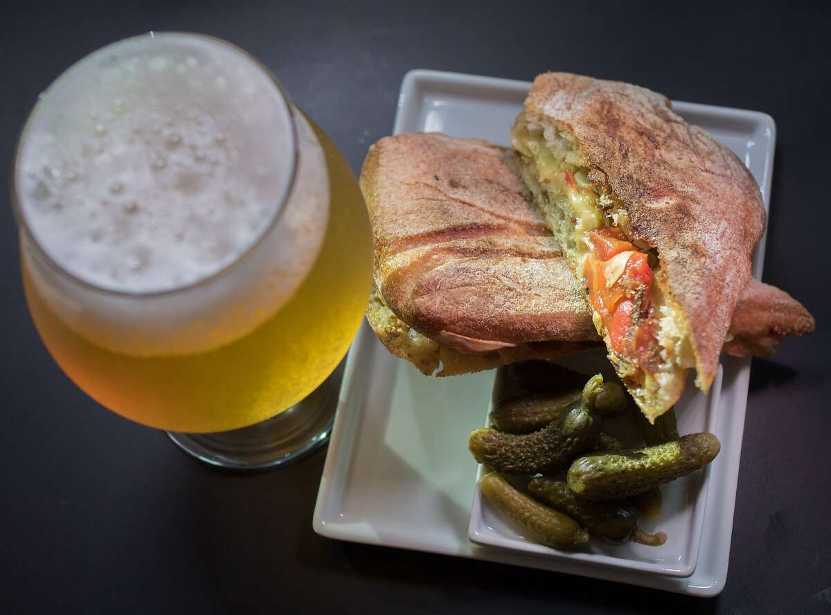 An Artichoke & Roasted Red Pepper Panini with a Faction Brewing Belgian Ale at the Cadet wine bar in Napa, Calif., is seen on Saturday, August 9th, 2014.