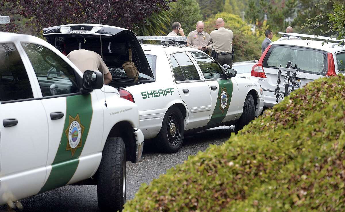 Marin County Sheriff's detectives investigate the shooting deaths of two men in neighboring backyards on Carlota Circle in the Strawberry neighborhood of Mill Valley, Calif., Thursday, Aug. 21, 2014.