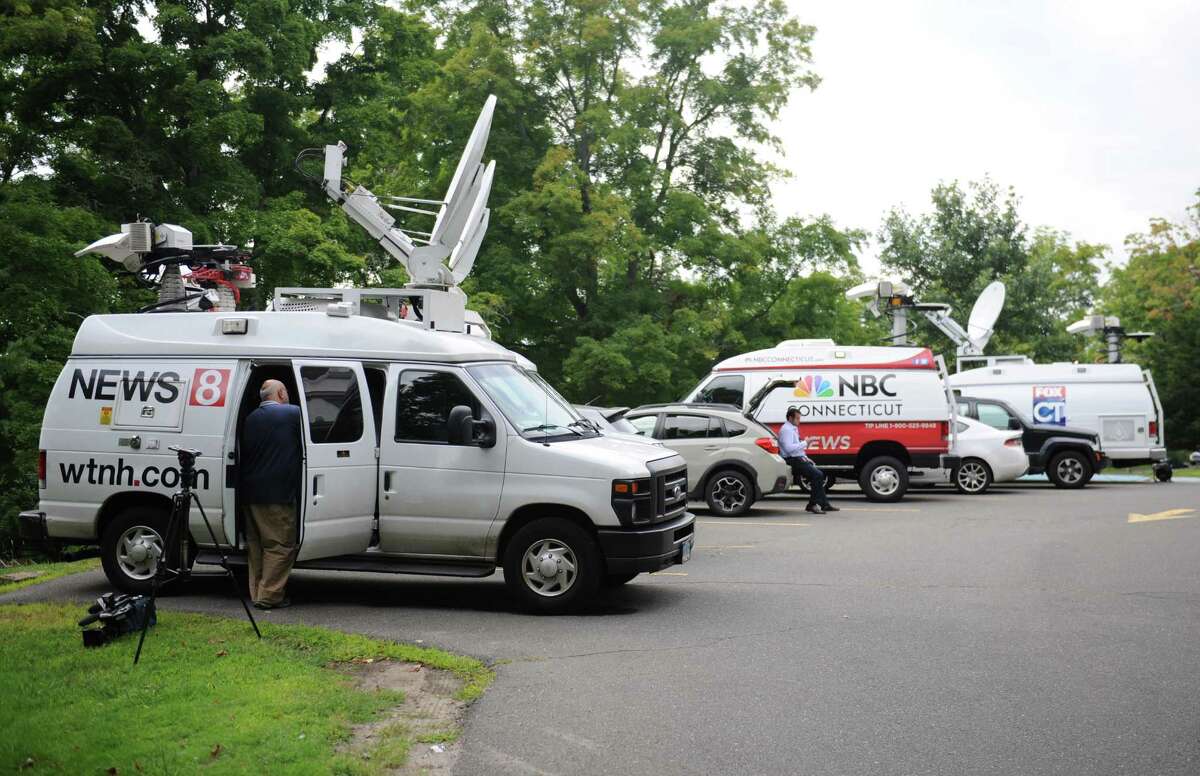 Media wait outside the Ridgefield Police Station in Ridgefield, Conn. Thursday, Aug. 21, 2014. The medical examiner ruled the July 7 death of 15-month-old Benjamin Seitz a homicide. Police said the child's father, Kyle Seitz, was supposed to drop the boy off at daycare, but instead left the child in his car in the parking lot of his workplace for an extended period of time.