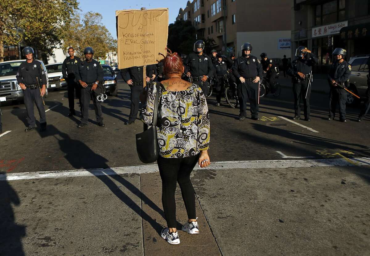 LaNora Anderson confronts a lone of Oakland Police at 8th and Broadway while taking part in a protest in support of Ferguson, Missouri residents in Oakland, Calif. on Wednesday, August 20, 2014.