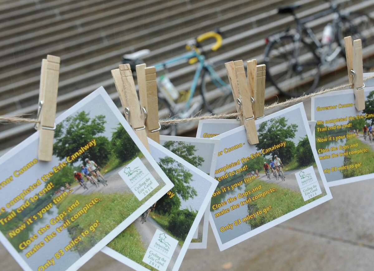 Bikers from Parks & Trails New York drop-off hundreds of postcards to the Capitol from riders who have recently completed the annual, cross-state Cycling the Erie Canal bike tour, urging the Governor to close the gaps that remain in the Erie Canalway Trail on Friday, Aug. 22, 2014, in Albany, N.Y. (Lori Van Buren / Times Union)
