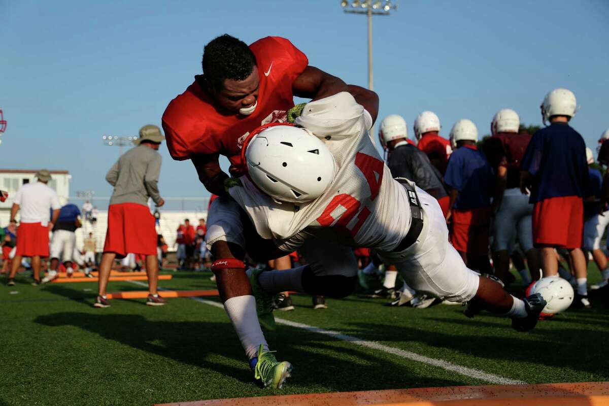 Katy High School players participate in contact drills during fall football practice first day of full pads Friday, Aug. 15, 2014, in Katy, Texas.