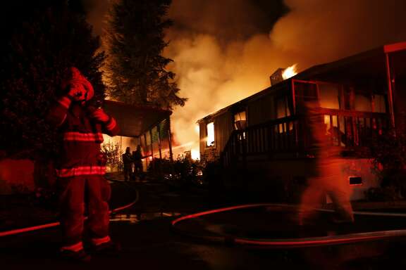 Napa Firefighters work on extinguishing in mobile home park in Napa, Calif. on Sunday, August 24, 2014,