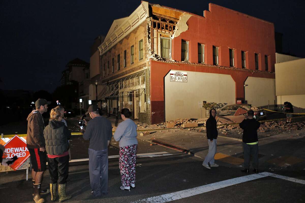 Residents of Napa check out damage to a building at Third and Brown Streets in Napa, Calif., after a strong earthquake hit the San Francisco Bay Area centered near American Canyon on Sunday, August 24, 2014.