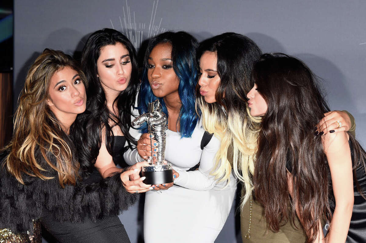 Fifth Harmony members show off their Artist to Watch trophy at the 2014 MTV Video Music Awards at The Forum in Inglewood, California.