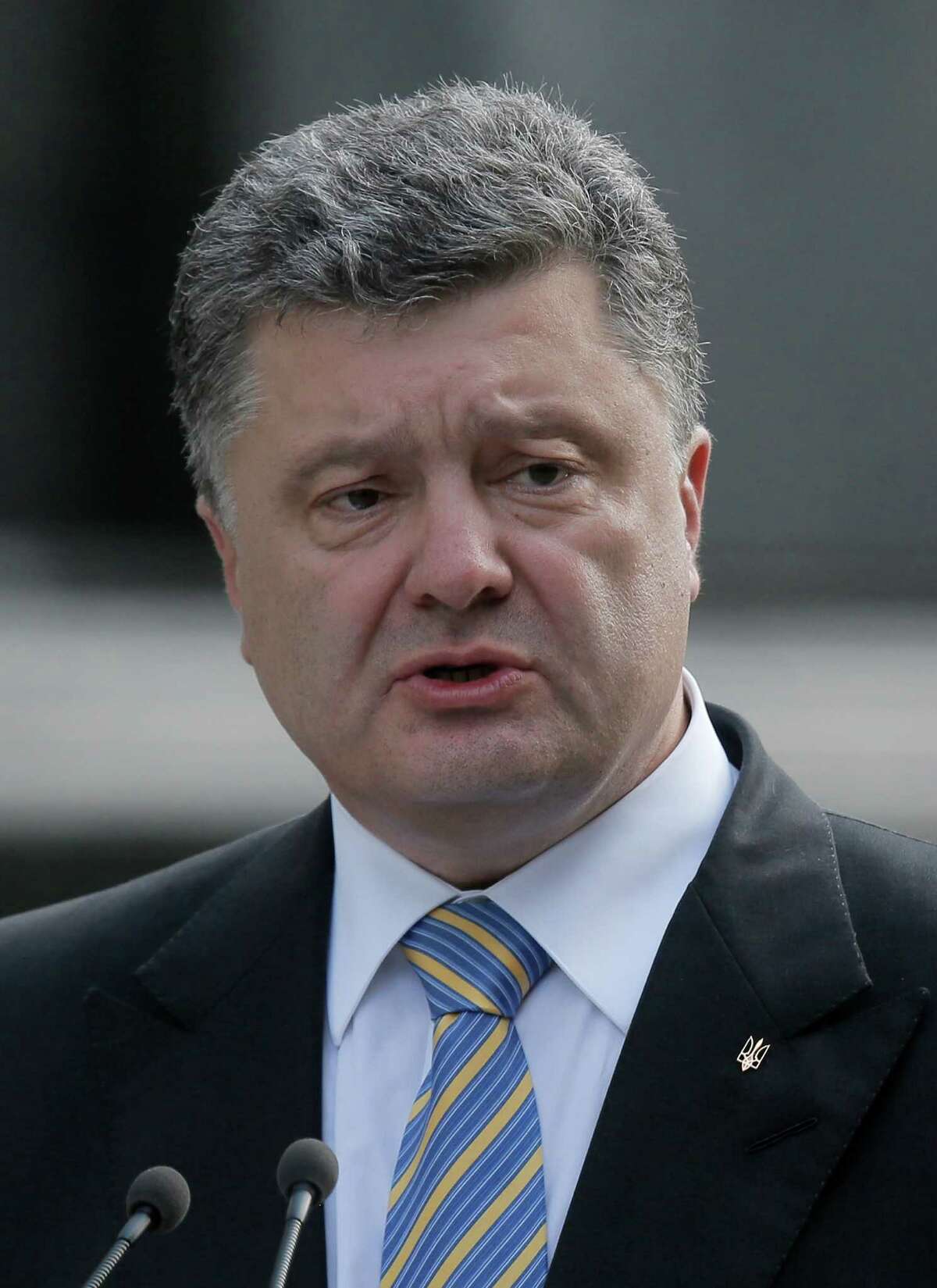 In this photo taken on Saturday, Aug. 23, 2014, Ukraine's President Petro Poroshenko makes a statement to the press in Kiev, Ukraine. Poroshenko on Monday, Aug. 25, dissolved parliament and called for early elections in October 26 as his country continues to battle a pro-Russian insurgency in its eastern regions. (AP Photo/Efrem Lukatsky)