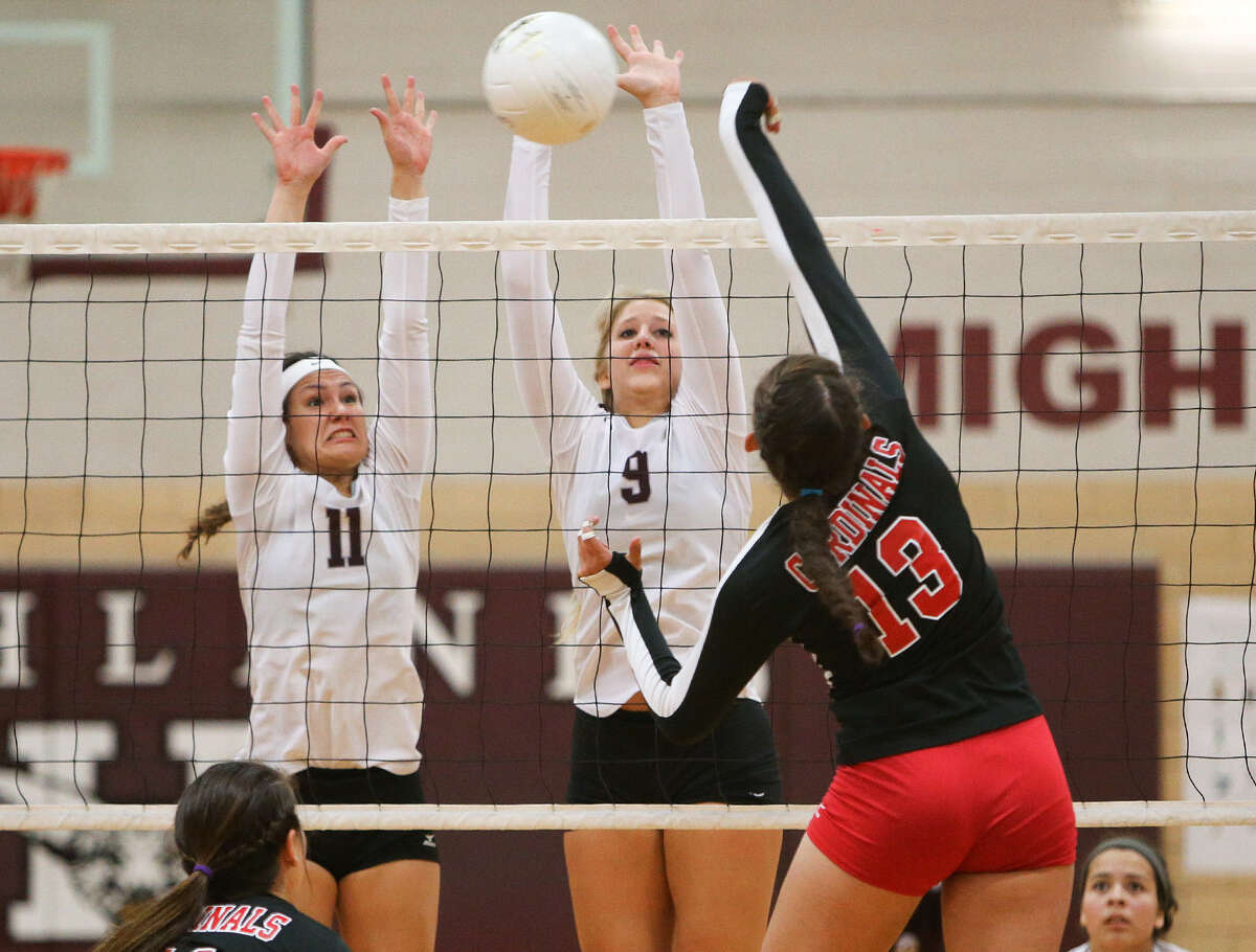 Southside's Chloe Davis (13) gets a shot past Highlands' Emily Pearce (11) and Bryten Mitchan (9) during their season opener at Highlands on Wednesday, Aug. 13, 2014. Highlands won the match in five sets, 25-19, 25-21, 14-25, 17-25, 17-15. Photo by Marvin Pfeiffer / EN Communities