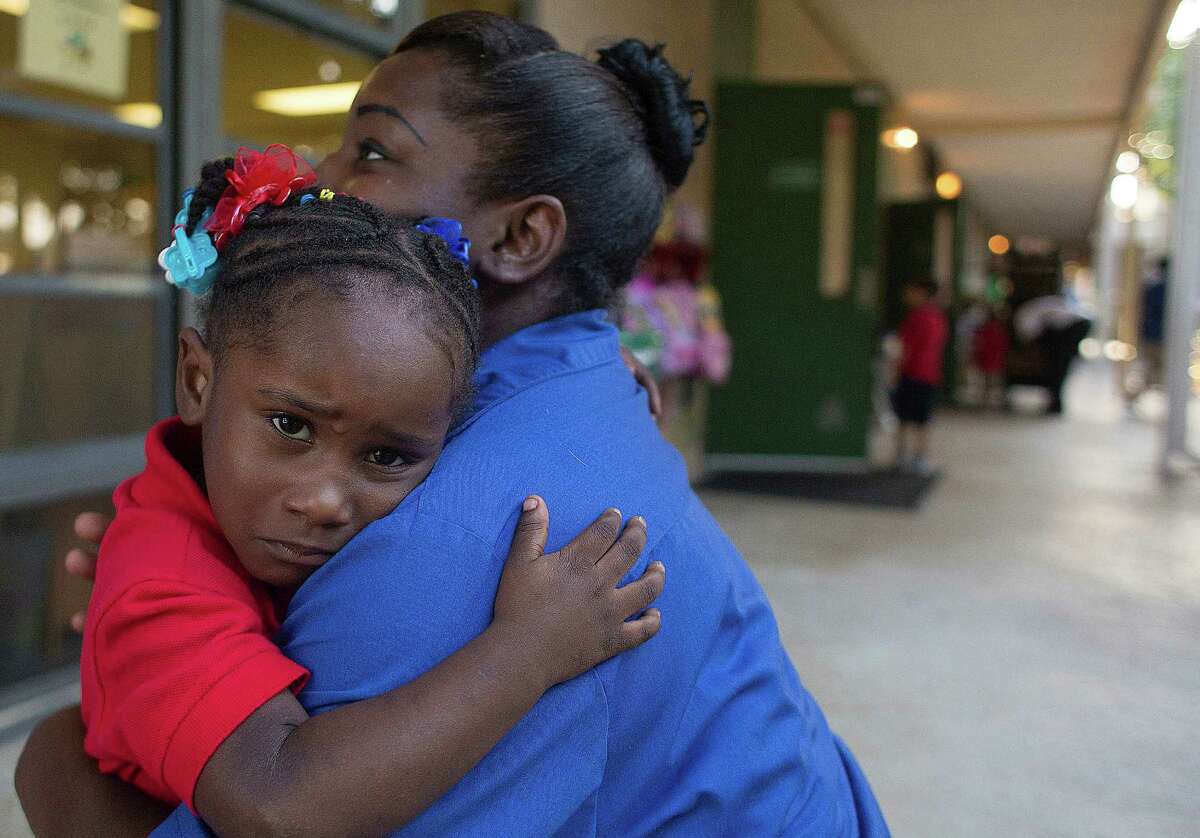 T'Ieviea Smith, 3, gets one last hug from her mom, LaTonya Smith, as she begins her first day at ﻿Garden Oaks Elementary School.﻿