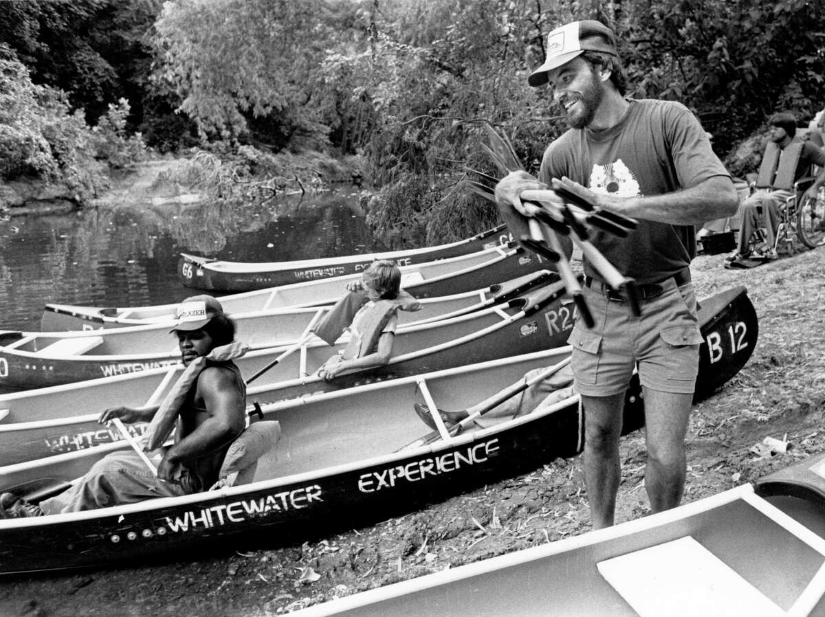 Don Greene in 1980, helping a group of wheelchair-bound people prepare for a canoe trip down Buffalo Bayou. (Chronicle file photo.)