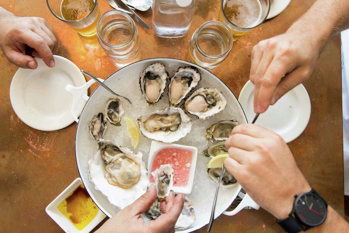 Diners enjoy oysters at the small neighborhood restaurant Red Hill Station in San Francisco.