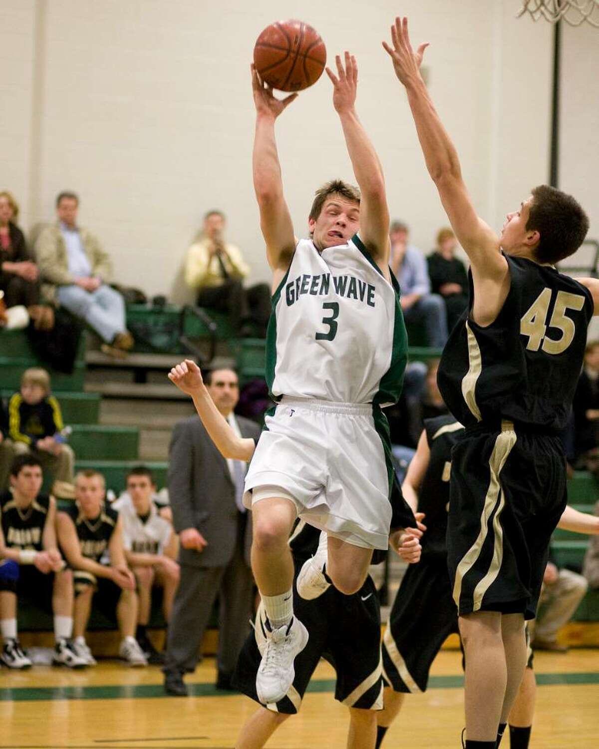 New Milford's John Krafick (3) puts up a shot over Joel barlow's Nelson Diaz during an SWC game Friday night at New Milford High.