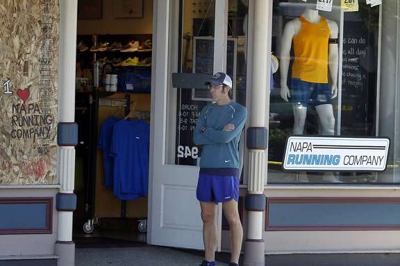 Louis Secreto waited for customers for his running shoe company on Main Street Tuesday August 26, 2014. Cleanup continued in downtown Napa, Calif. following the large earthquake early Sunday morning.