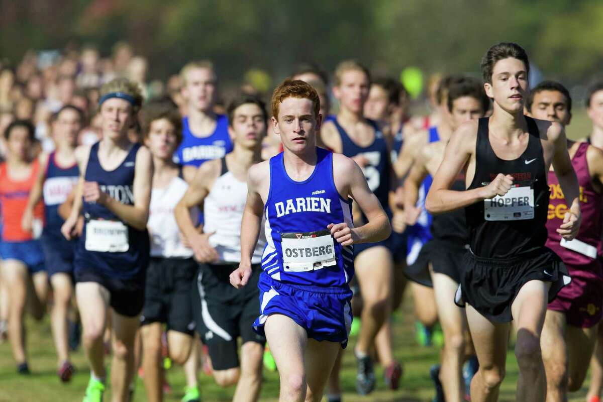 Darien's Alex Ostberg leads the pack during the 2013 FCIAC boys cross country championship at Waveny Park in New Canaan on Thursday, October 17, 2013.
