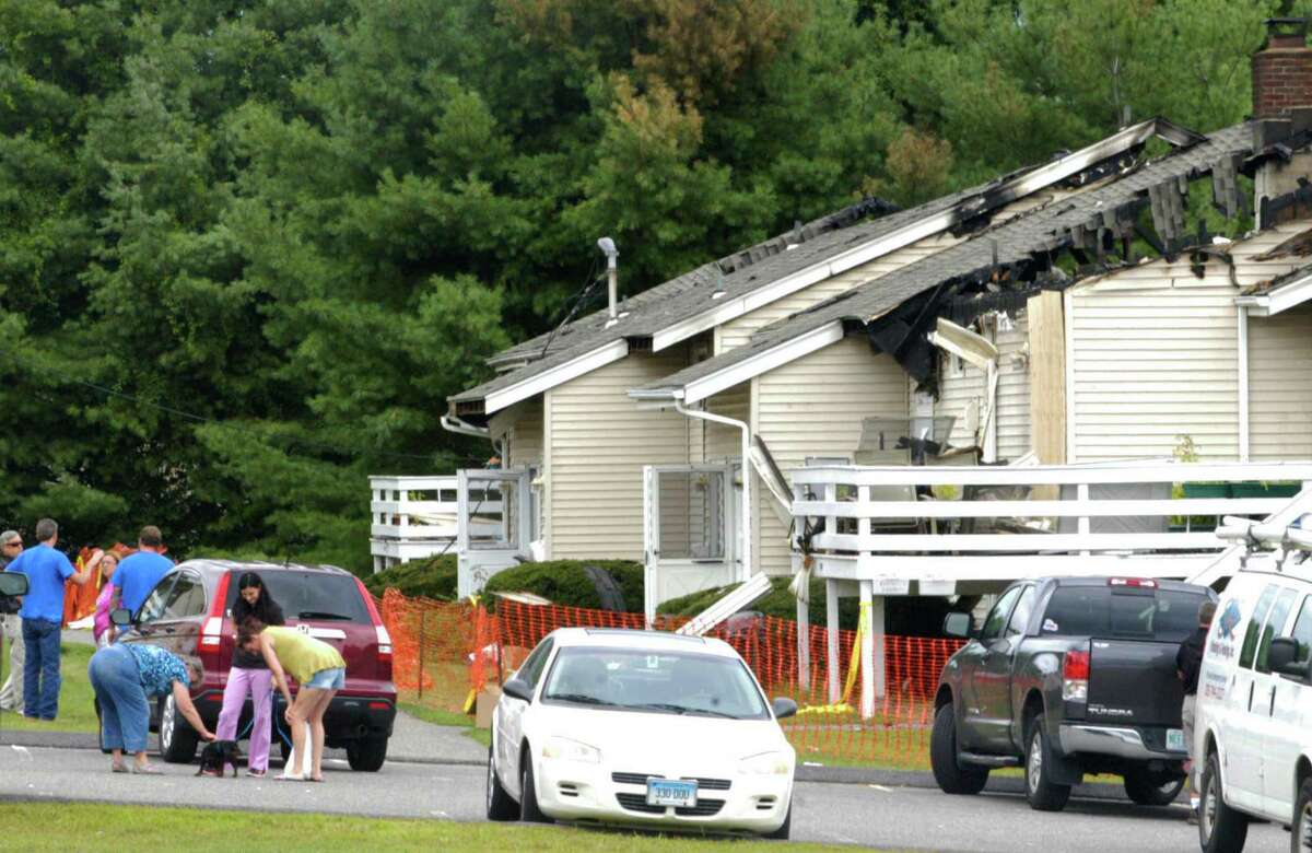 Family and friends gather at the Candlewood condominiums along Route 7 South in New Milford about 24 hours after a fire had destroyed several units and rendered their occupants temporarily without their homes. Aug. 22, 2014