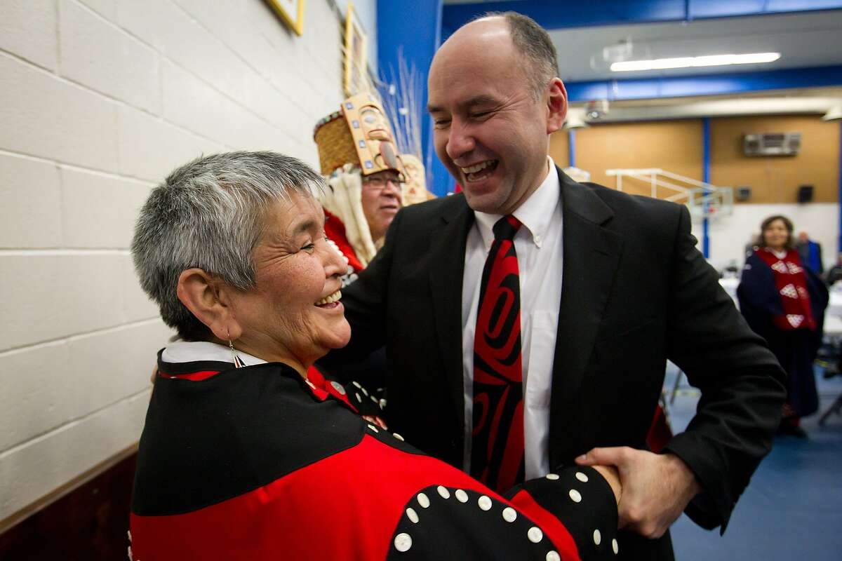 ADVANCE FOR USE SUNDAY, JAN. 29, 2012 AND THEREAFTER - In this Tuesday Jan. 10, 2012 photo, Haisla First Nation Chief Councillor Ellis Ross, right, laughs with Hereditary Chief Marilynn Furlan after he addressed the panel during the opening day of hearings for the Enbridge Northern Gateway Project in Kitamaat Village, British Columbia, Canada. Several hundred people gathered for hearings on whether a pipeline should be laid from the Alberta oil sands to the Pacific in order to deliver oil to Asia, chiefly energy-hungry China. The stakes are particularly high for the village of Kitamaat and its neighbors, because the pipeline would terminate here and a port would be built to handle 220 tankers a year and 525,000 barrels of oil a day. Ross used to work on whale-watching boats, and testified that the tanker port would go up just as marine life decimated by industrial pollution was making a comeback in his territory. (AP Photo/The Canadian Press, Darryl Dyck)