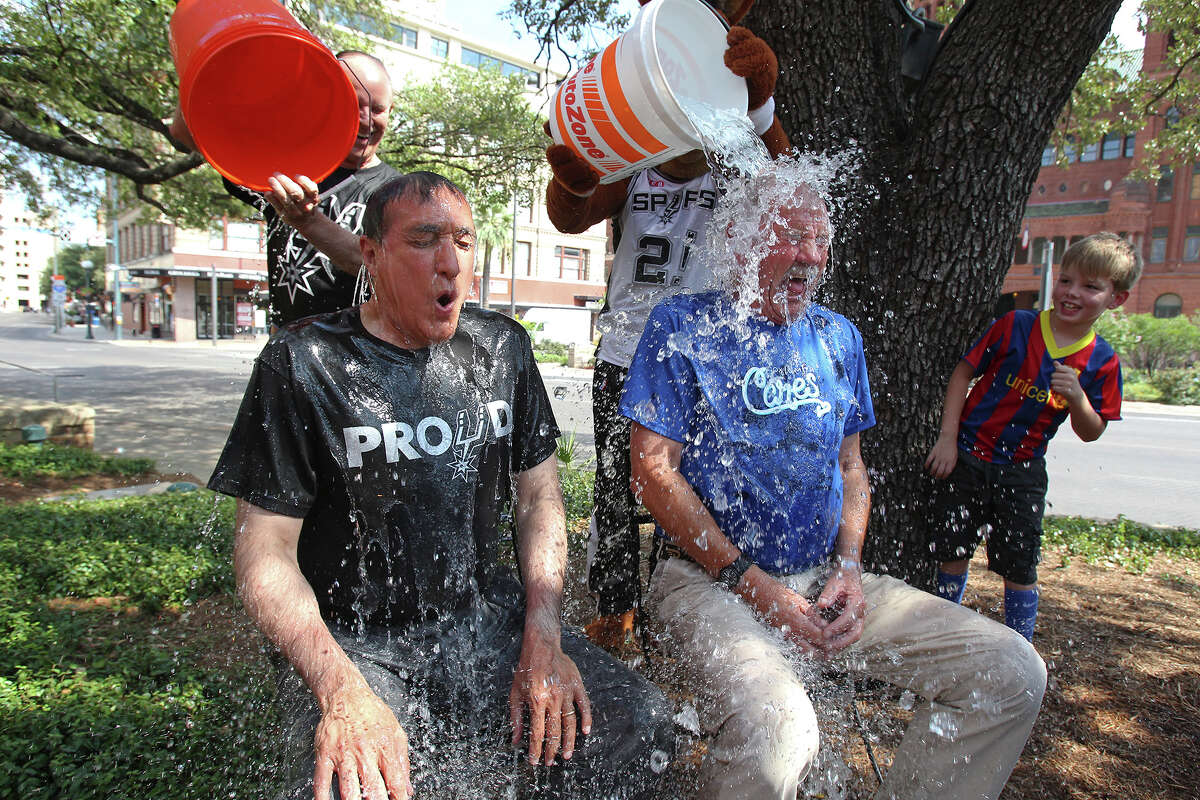 Former mayors Henry Cisneros and Phil Hardberger join with County Judge Nelson Wolff as the Spurs Coyote helps complete the ALS ice bucket challenge on Main Plaza in front of the Bexar County Courthouse on August 27, 2014. Coyote poured ice water on Judge Wolff and who later helped him drench Cisneros and Hardberger.