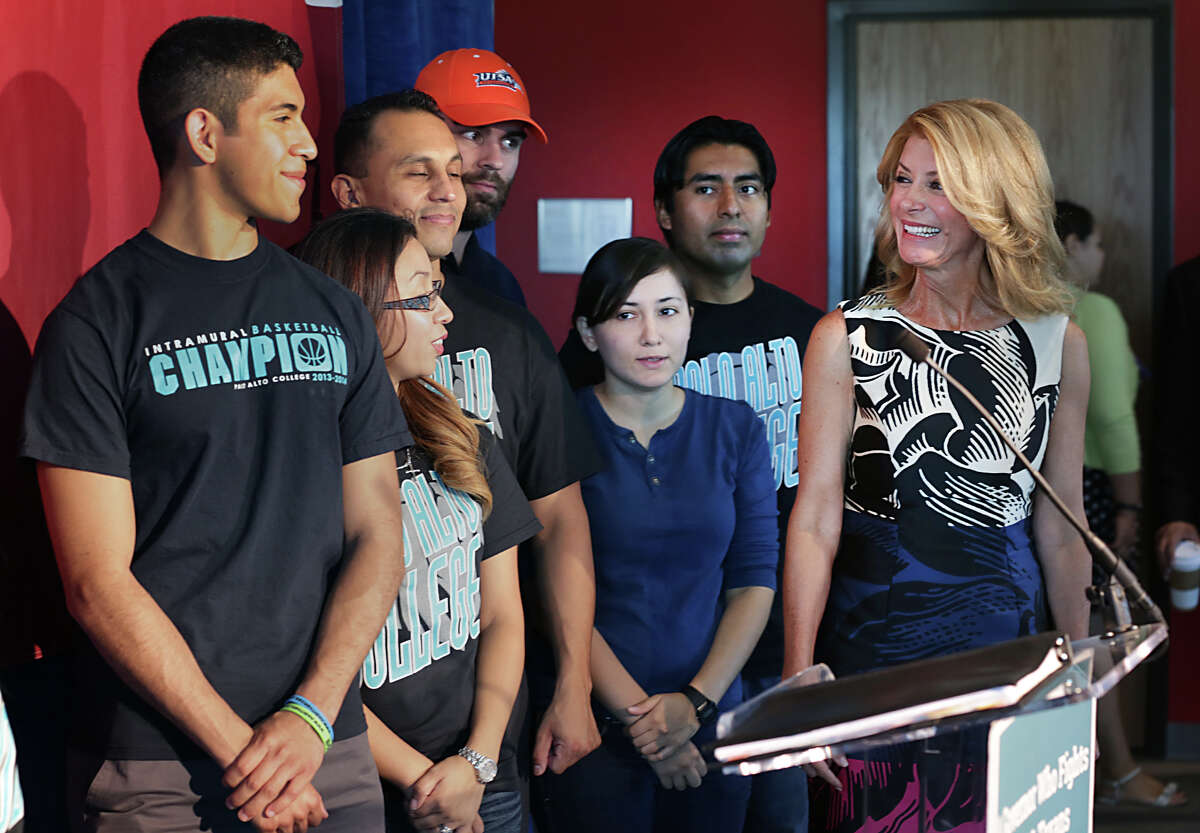 Democrat candidate for Governor of Texas, Senator Wendy Davis, right, smiles at Palo Alto College and UTSA students as she prepares to addressed the media outlining her ideas for higher education, during a press conference at Palo Alto College. Tuesday, Aug. 26, 2014.