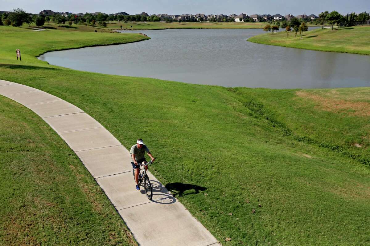 A dry detention area in Cinco Ranch, south of Katy, is landscaped with green-belt trails.